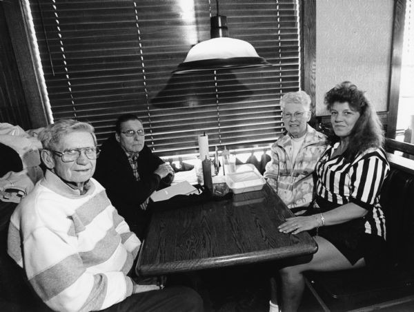 "Teri was our waitress at Coaches Corner Touch Down Club, Fond du Lac." From left to right, Ralph "Buddy" Ruecker, John P. Widmer, Shirley Widmer, and Teri.


