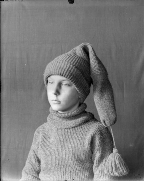 Head and shoulders portrait of Forest Middleton wearing matching knit sweater and long stocking cap with tassel.