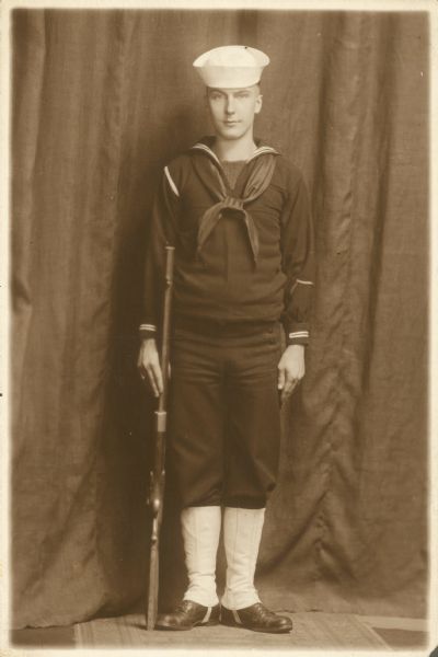 Full-length portrait of Forest Middleton in a World War I era Navy uniform.