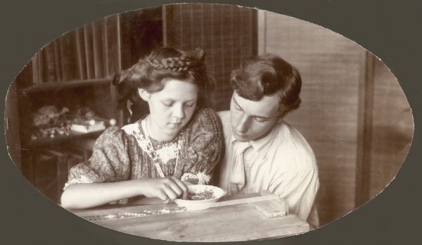 Forest Middleton and his future wife, Leonore Judkins, look over a piece of beadwork on a frame.