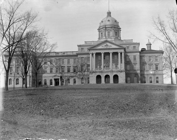 Main Hall, later renamed Bascom Hall, on the University of Wisconsin-Madison campus. The dome was destroyed in a fire in 1916. Later additions made the building symmetric.