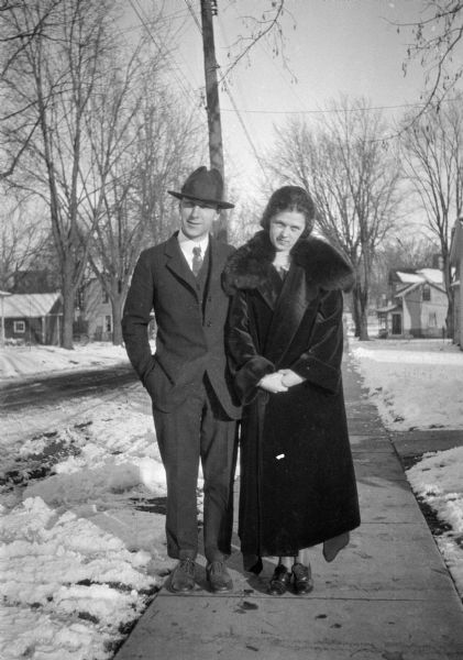 Forest and Leonore Judkins Middleton pose on a sidewalk. There is snow on the ground.