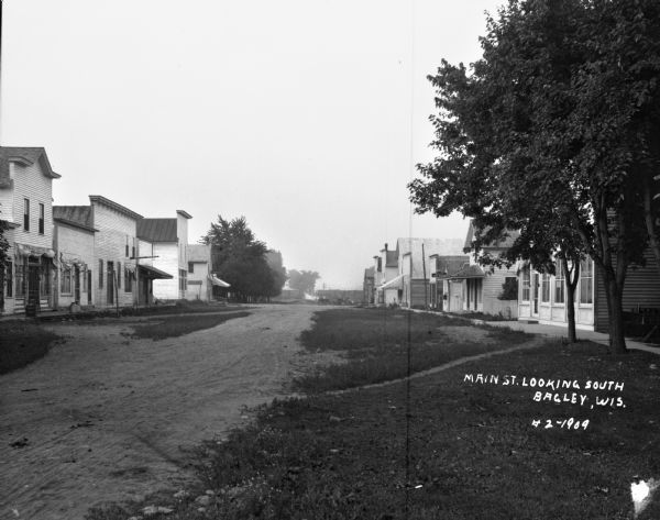 View down Main Street. Osward's restaurant is on the far left. The post office and a plumbing shop are on the right.