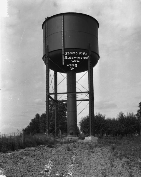 A water tower with a ruler indicating the amount of the water inside.