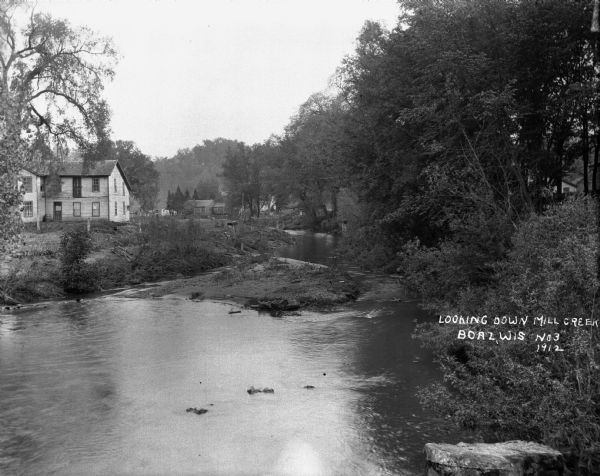 View across the creek of two houses.