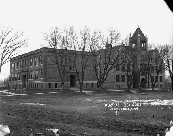 View of the public school from across a yard.