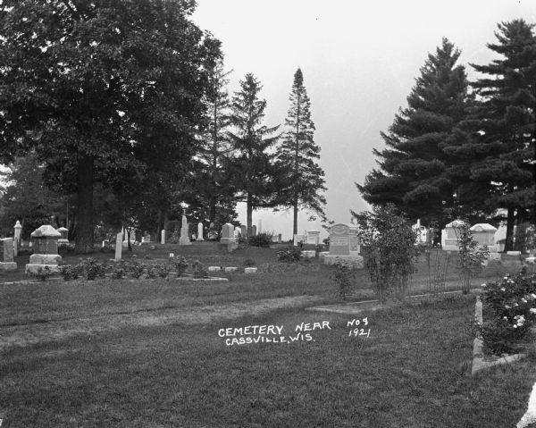 Rows of tombstones at the cemetery. The gravestone of Myrtle Schmelz is legible.