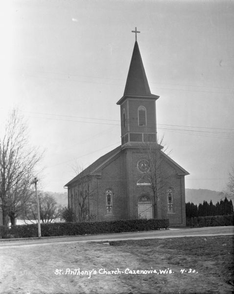 Exterior of the Church. The building features stained glass, double doors, and a tall steeple.