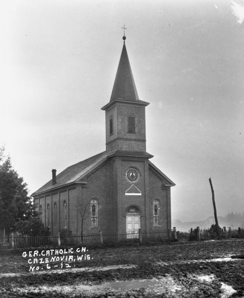 Exterior view of Saint Anthony's Church. The building features stained glass, double doors, and a tall steeple.