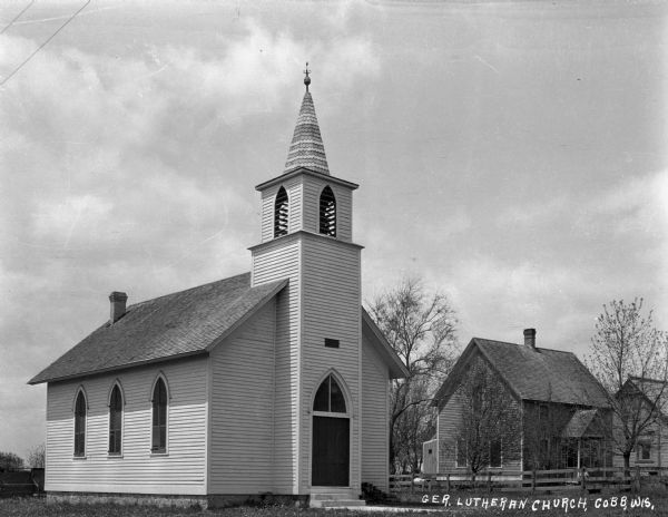 Exterior of the German Lutheran Church, which features lancet arched windows and door, and a steeple.
