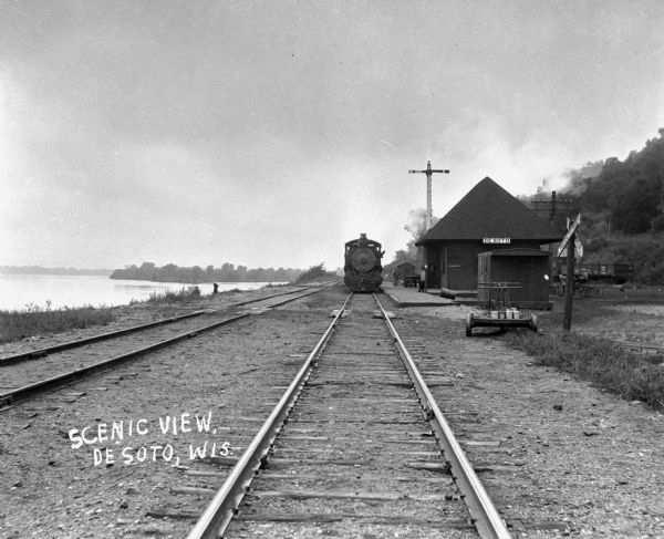 Locomotive at the De Soto depot on the Chicago, Burlington and Quincy Railroad line. The Mississippi River is on the left.