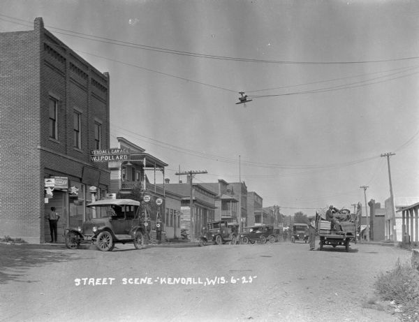 View down a commercial street, primarily documenting W.J. Pollard's garage.