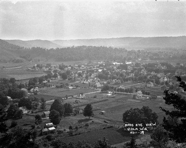 Elevated view of Viola and neighboring farms in a valley surrounded by rolling hills.