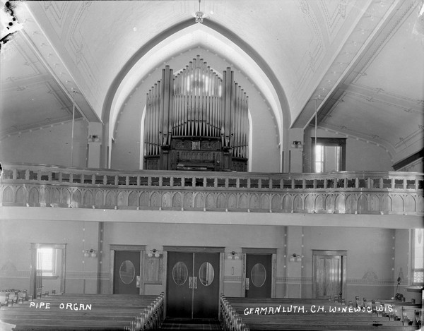 Interior view including the pipe organ in the German Lutheran Church. The pews on the first floor, the organ in the balcony.