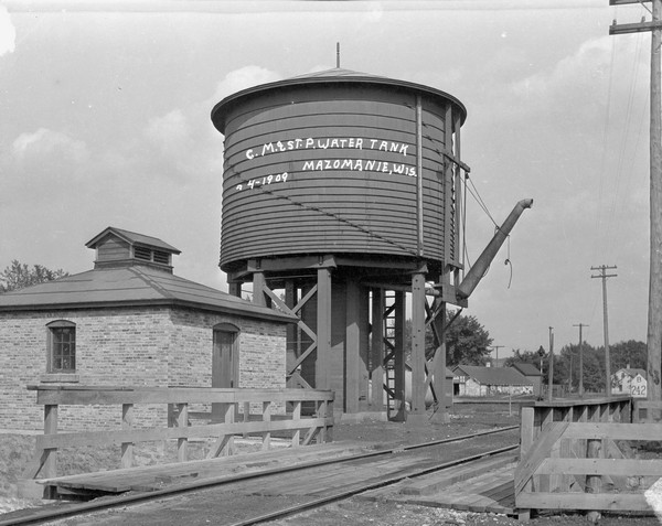 View over railroad tracks towards the railroad water tank.
