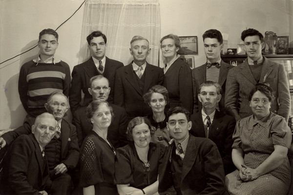 Group portrait of Sherwin Gillett's extended family. Top row: Gerald Baumeister, son of Sherwin's sister, Helen; Lorin Gillett, son of Sherwin; Rufus Gillett, Sherwin's brother; Gertrude Gillett, Rufus's wife; Keith Baumeister, son of Sherwin's sister, Helen; George Baumeister, son of Sherwin's sister, Helen. Middle row: Sherwin Gillett, George Brassington; husband of Sherwin's sister, Ruth; Beth Gillett, wife of Fred; Fred Gillette, Sherwin's brother; Emma Gillette, Sherwin's wife. Bottom row: ? Brassington, an in-law; Ruth Brassington' Sherwin's sister; Helen Brassington, Sherwin's sister; Dale Gillette, son of Sherwin's brother, Rufus.