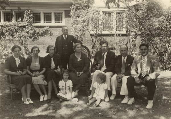 Outdoor group portrait of the extended Elston family, including sons-in-law and grandchildren.