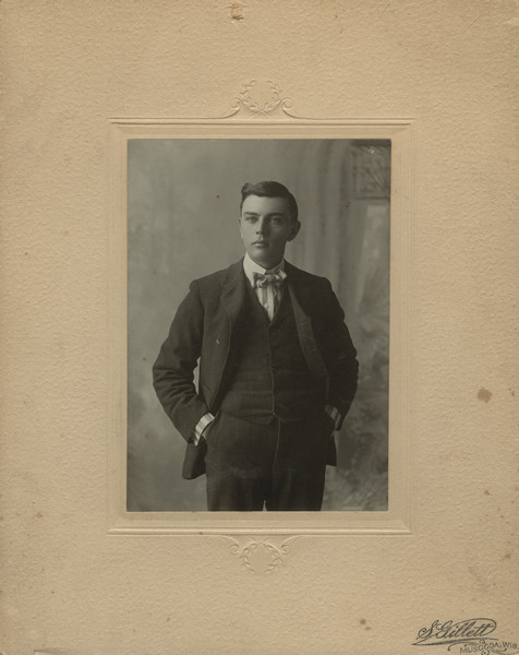 Three-quarter length portrait of Sherwin Gillett. The frame has the S. Gillett imprint, but the photograph is from years before he started his own photography business. Until 1905 he was living in Fitchburg with his mother.