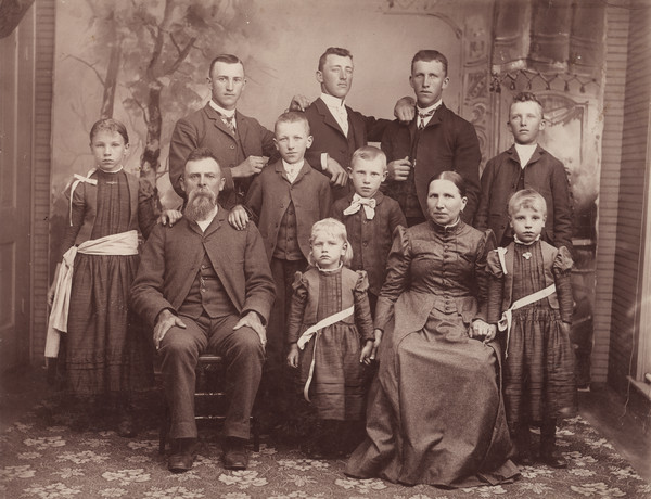 Group portrait in front of a painted backdrop of the Conrad Schmitt family of Muscoda. Emma Schmitt married Sherwin Gillett in 1906.