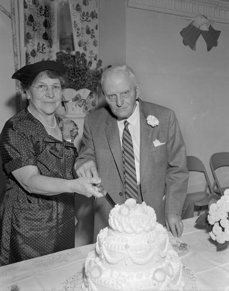 Sherwin and Emma Gillett cutting the cake at their 50th Wedding Anniversary banquet.