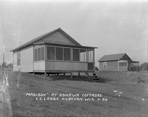 Exterior view of the "Madison" cottage. There are steps to the corner entrance of the screened-in porch. There is another cottage in the background on the right.