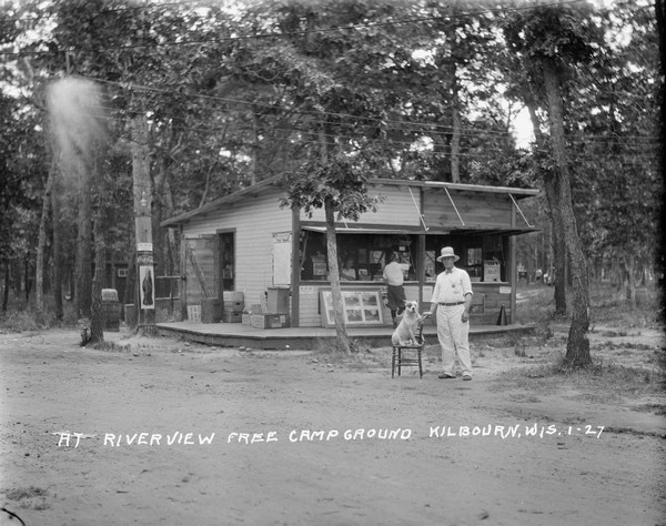 The general store and boat tour ticket selling counter. A man and a dog are posing in the foreground.