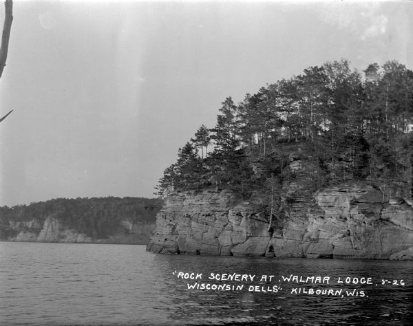 View across Wisconsin River of tree-covered bluffs along the shoreline.