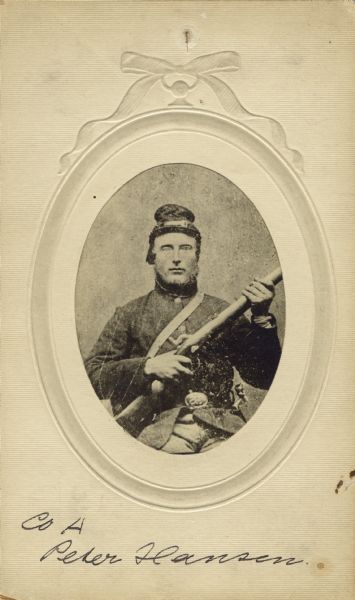 Waist-up seated oval studio portrait of Peter Hanson, a private in Company A, 15th Wisconsin infantry, wearing his uniform. He is holding his musket across his lap and a bayonet in its scabbard on his side. The following information was obtained from the Regimental and Descriptive Rolls, Volume 20: He resided in Bad Ax County, Wisconsin. On December 16, 1861, he enlisted and was mustered into service in Madison, Wisconsin on December 20, 1861, at the age of 40. During the war, he was detached to serve with the Pioneer Corps. On September 14, 1864 he was sent to work on the Chattanooga, Tennessee water works. He was mustered out of service with Company A on December 20, 1864, at Chattanooga, Tennessee