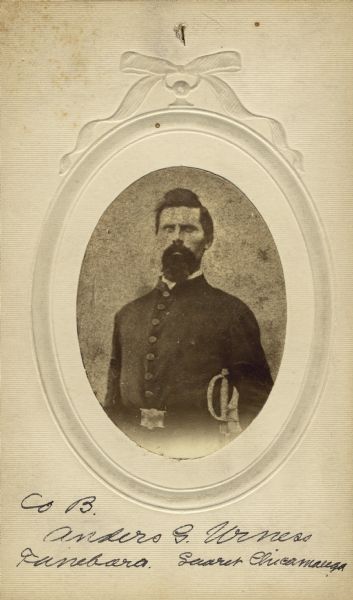 Waist-up oval studio portrait of Anders G. Urness [as written on portrait backing; also written as Anders G. Urnces on the published Roster of Wisconsin Volunteers, Volume 1 and (“Red Books”) Regimental and Descriptive Rolls, Volume 20; Anders G. Urnaes as on the ("Blue Books) Regimental and Descriptive Rolls, Volume 20], a sergeant in Company B, 15th Wisconsin Infantry in uniform with sword sheathed on his side.  The following information was obtained from the Regimental and Descriptive Rolls, Volume 20: He resided in Black Earth, Wisconsin. On November 16, 1861, he enlisted and was mustered into service in Madison, Wisconsin on December 02, 1861, at the age of 24.  He was wounded in the chest at the Battle of Chickamauga on September 19, 1863. In November 1863, he was absent from muster rolls for conducting recruiting service.  In July 1863, he became the Regimental Color Bearer until he was mustered out with Company B on December 2, 1864, at Chattanooga, Tennessee.