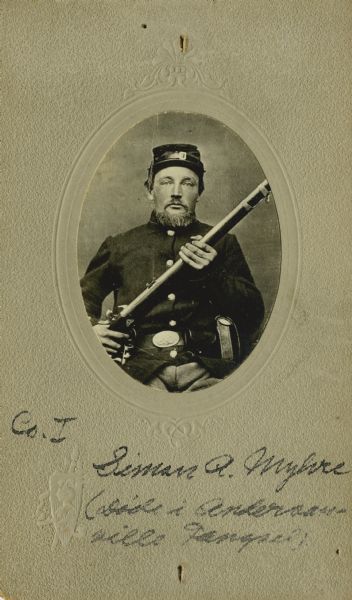 Waist-up seated oval studio portrait of Peter A. Myhre, a corporal in Company I, 15th Wisconsin Infantry in uniform holding a musket across his chest. The following information was obtained from the Regimental and Descriptive Rolls, Volume 20: He resided in St. Laurence, Wisconsin. On December 9, 1861, he enlisted in Scandinavia, Wisconsin and on December 20, 1861, he was mustered into service in Madison, Wisconsin at the age of 26. On December 5, 1864, he was promoted to corporal. He was captured on May 27, 1864 near Dallas, Georgia during the Battle of New Hope Church. On October 4, 1864, he died of scarbutis at the prisoner of war camp in Andersonville, Georgia. He is buried at the Andersonville National Cemetery, grave: 1028.