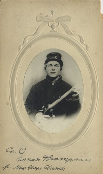 Waist-up oval portrait of Oscar Thompson, a private in Company G, 15th Wisconsin Infantry, in uniform and holding a musket across his chest. The following information was obtained from the Regimental and Descriptive Rolls, Volume 20: He resided in Beloit, Wisconsin. On December 2, 1861, he enlisted in Beloit, Wisconsin and on December 13, 1861, he was mustered into service in Madison, Wisconsin at the age of 18. On October 13, 1863, he served as a guard with a supply train. On May 27, 1864, during the fighting on Altoona Mountain, near New Hope Church, Georgia, he was killed with a shot through his head.