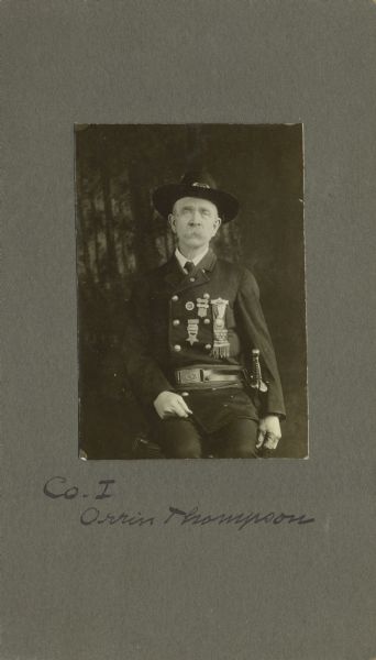 Three-quarter length seated portrait of Orvin Thompson, a private in Company I, 40th Wisconsin Infantry, wearing Grand Army of the Republic uniform and a sword at his side. The following information was obtained from the Regimental and Descriptive Rolls, Volume 45: He resided in Sun Prairie, Wisconsin. On May 21, 1864, he enlisted in Madison, Wisconsin and on June 16, 1864, he was mustered into service in Madison, Wisconsin at the age of 18. He served his contracted 100 day term of service and was mustered out at Camp Randall in Madison, Wisconsin on September 16, 1864.