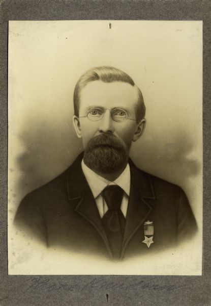 Head and shoulders studio portrait of Thore Knudson, a musician in Company E, 15th Wisconsin Infantry. The following information was obtained from the Regimental and Descriptive Rolls, Volume 20: He resided in Berry, Wisconsin. On December 7, 1861, he enlisted in La Crosse, Wisconsin and was mustered into service at Madison, Wisconsin on December 20, 1861, at the age of 24. He mustered out with Company E on December 20, 1864, at Chattanooga, Tennessee.