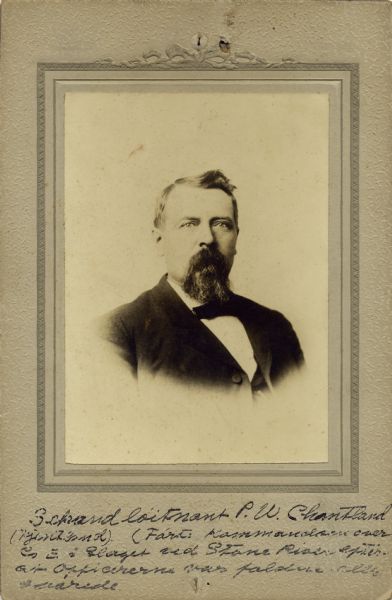 Quarter-length studio portrait of P.W. Chantland [as written on the photograph backing; also written and known as Peter W. Chantland on Descriptive Rolls, Volume 20, published rosters: Wisconsin Volunteers (1914) and Rosters of Wisconsin Volunteers, Volume 1 (1886)], a captain in Company F, 15th Wisconsin Infantry. The following information was obtained from the Regimental and Descriptive Rolls, Volume 20: He resided in Primrose, Wisconsin. On November 01, 1861, he enlisted in Dane County, Wisconsin and on November 12, 1861, he was mustered into service at the age of 22. On enlisted he held the rank of first sergeant and in April 1863, he was commissioned as a second lieutenant at Murfreesboro, Tennessee. He resigned his commission and was mustered out of service do to disability in November 1861 at the headquarters of the Department of the Cumberland in Chattanooga, Tennessee.