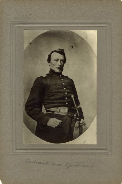 Three-quarter length studio portrait of Iver William Tjentland a first lieutenant in Company E, 15th Wisconsin Infantry, in uniform.  The following information was obtained from the Regimental and Descriptive Rolls, Volume 20: He resided in Moscow, Wisconsin. On December 09, 1861, he was commissioned as a first lieutenant by the governor of Wisconsin and was mustered into service on December 10, 1861, in Madison, Wisconsin at age 33. He resigned his commission on September 3, 1862 and was accepted by General Ulysses S. Grant.