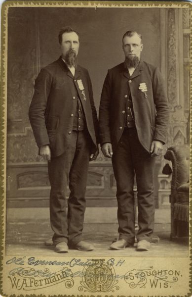 Full-length cabinet card portrait in front of a painted backdrop of (right) Ole Everson Luten [as on the photograph backing; also written as Ole Everson on Descriptive Rolls, Volume 20, and on published rosters: Roster of Wisconsin Volunteers, Volume 1 (1886) and Wisconsin Volunteers (1914)], a private in H Company, 15th Wisconsin Infantry and (left) Andrew Ellickson, a private in C Company, 15th Wisconsin Infantry. 

The following information was obtained from the Regimental and Descriptive Rolls, Volume 20: Ole Everson Luten resided in Stoughton, Wisconsin. On November 26, 1861, he enlisted and on February 13, 1862, was mustered into service in Madison, Wisconsin at the age of 18. On May 17, 1863, he was sent to a convalescent camp near Murfreesboro, Tennessee. On January 31, 1864, he was transferred to 68th Indiana Infantry at Maryville, Tennessee. He was mustered out of service with Company H, on February 13, 1865, in Chattanooga, Tennessee. On May 22, 1867, he received brevetted rank of captain for gallantry displayed by him during the battle at Kennesaw Mountain, Georgia on June 27, 1864.  

Andrew Ellickson held residence in Pleasant Springs, Wisconsin. On March 14, 1862, he enlisted and on March 21, 1862, was mustered into service in Madison, Wisconsin at the age of 22.  He was captured during the battle at Chickamauga, Georgia on September 19, 1863.  He was mustered out of service on March 21, 1865, at Madison, Wisconsin.