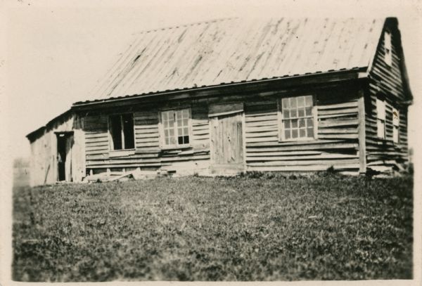 Wooden building with attached structure.