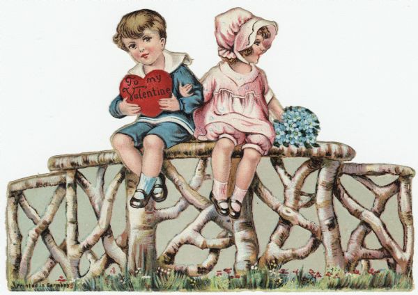 Valentine's Day card of a boy dressed in a blue sailor suit and a girl dressed in a pink outfit and bonnet. They are sitting arm in arm. He is holding a heart that reads: "To My Valentine" and she is holding a bouquet of blue Forget Me Not flowers. They are sitting on a fence made of intertwined birch branches, and grass and flowers are below. Chromolithograph, embossed and die cut. Printed in Germany.