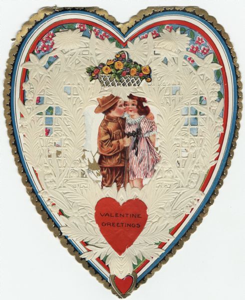 Valentine created using a "Whitney's Valentine Material" kit. The "folder" (card) has a boy in military uniform holding a rifle. He is kissing a girl on the cheek. She is wearing a red and white striped dress. In the background is a military camp with tents over which fly the American flag. Above the couple are flowers. Over that paper lace is attached by paper springs. On top are two ornaments, a basket of flowers and a heart with the text "Valentine Greetings." Offset lithography, embossed and die cut.