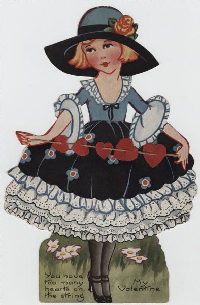 Valentine's Day card with a woman holding a string with five hearts hanging on it. She is wearing a blue and black dress with white ruffles at the neckline, sleeves and skirt. Her hat is blue and black with a rose in the hatband and she is wearing black shoes. She is standing in the grass with flowers in the background. At the foot is the text: "You Have Too Many Hearts On The String, My Valentine." Offset lithography and die cut. There is an easel on the back.