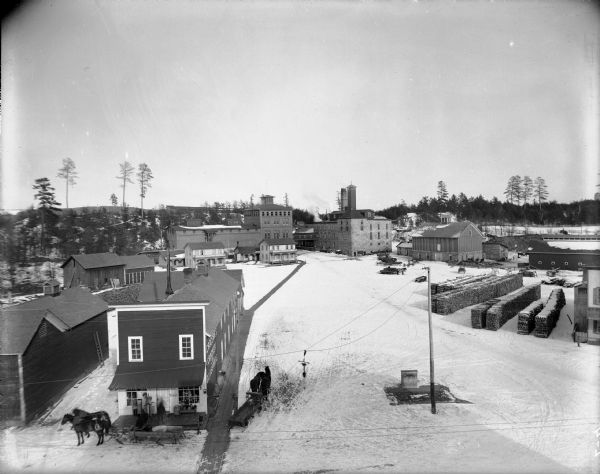 Elevated winter view of the Leinenkugel Brewery seen "from top of Mill." Originally called "Spring Brewery," Jacob Leinenkugel opened his brewery in 1867 in partnership with John Miller. In 1883 Miller sold his share to Leinenkugel and the name was changed to "Leinenkugel's Spring Brewery." Jacob Leinenkugel passed away in 1898 and management was handed to his son-in-law Henry A. Casper and the brewery changed to the "Jacob Leinenkugel Brewing Company."