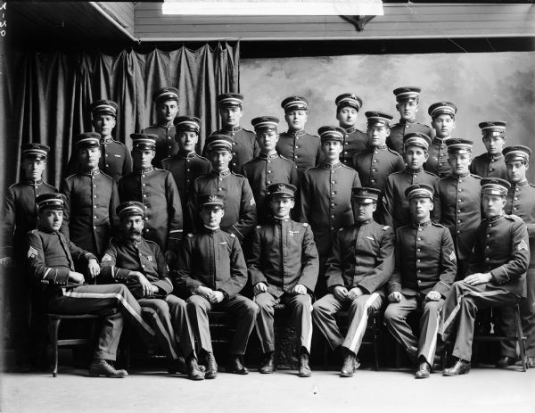 A studio portrait of Company C of the Wisconsin National Guard in uniform.