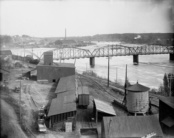 Elevated view of the riverfront, railroad tracks, and river, "as viewed from Joseph McGuire's."