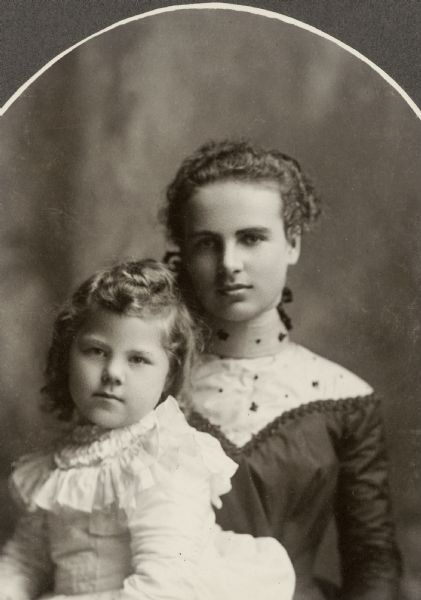 Mary Margaret (Margery) Bish, young daughter of the photographer and later Mrs. Clyde Bowman, sits on the lap of an older woman, possibly her mother.