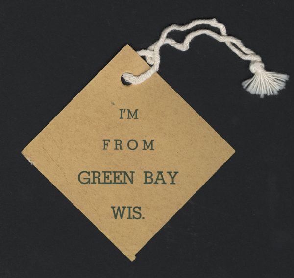 A one-sided badge with the words "I'm From Green Bay Wis." printed on it.