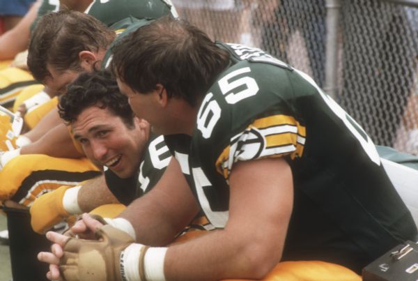 Green Bay Packers Ron Hallstrom (#65) and Randy Wright (#16) on the sideline during a preseason game against the New York Jets that took place at Camp Randall Stadium in Madison, WI. This was the largest crowd ever to see the Packers play in Wisconsin and the first pro football game ever held in Madison. The Packers won the game 38 to 14.