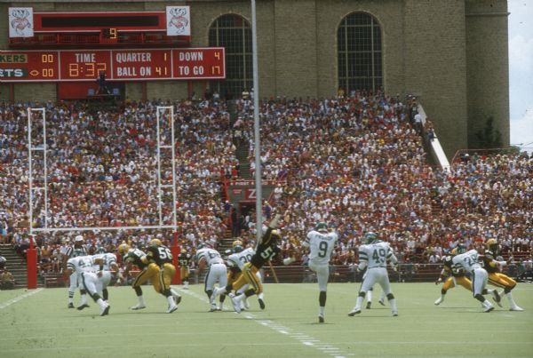 The New York Jets punting to the Green Bay Packers in a preseason game that took place at Camp Randall Stadium. This was the largest crowd ever to see the Packers play in Wisconsin and the first pro football game ever held in Madison. The Packers won the game 38 to 14.