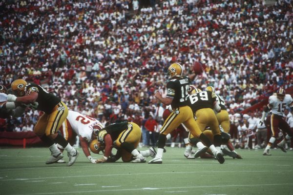 Green Bay quarterback David Woodley (#19) throwing a pass in a preseason game against the Washington Redskins that took place at Camp Randall Stadium. The Packers lost 0 to 33.