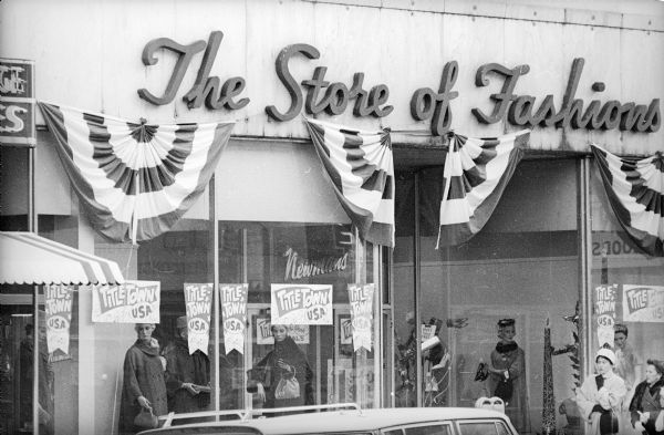 View from across street of the window display for Newman's "The Store of Fashions," which featured numerous "Titletown U.S.A." signs. The Packers were about to play for, and would go on to win, their seventh title as World Champions of Pro Football.