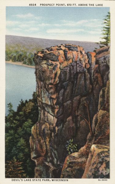 Colorized postcard of the rock formation called Prospect Point in Devil's Lake State Park. Trees and foliage can be seen all around. The lake, shoreline, bluffs and sky are visible in the background. The text above reads "Prospect Point, 610 Ft. Above the Lake."